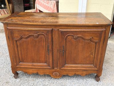 a wooden cabinet with a door on top of it