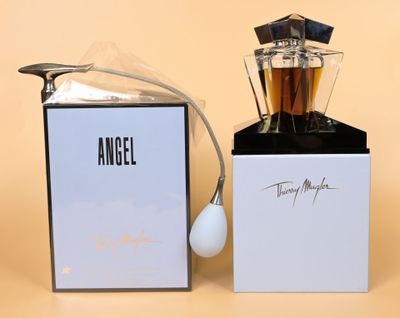 an image of a bottle of angel next to a box of perfume