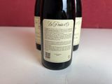 two bottles of wine sitting on a table