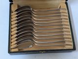 several spoons are in a box with a lid on a table