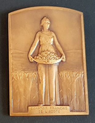 a plaque of a woman holding a basket of flowers