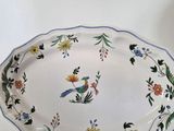 a platter with a bird and flowers on it