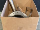 a cardboard box with a metal object inside of it