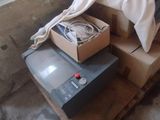 a television sitting on top of a pallet in a room