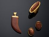 two pieces of jewelry including a horn, a ring, and a broochle