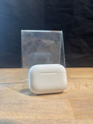 a small white object sitting on a table next to a clear box