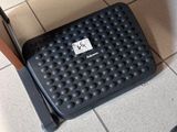 a black foot stool sitting on the floor next to a computer