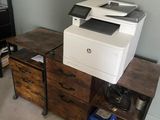 a printer sitting on top of a desk in a room