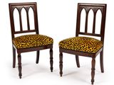 pair of mahogany chairs with leopard print upholstered seats