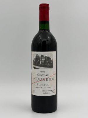 a bottle of red wine sitting on top of a white table