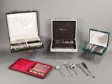 many different types of silverware on display in a case