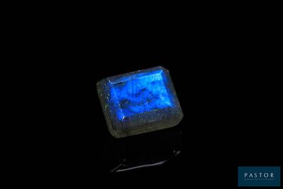 an image of a glowing blue stone on a black surface