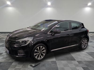 a black car is parked on a checkered floor in a garage