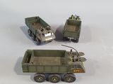 three toy army vehicles that are sitting on a table