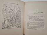 an open book with a black and white drawing of a map