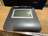 a pen sitting on top of a tablet computer on a desk
