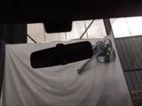 an image of a car ' s rear view mirror in a garage