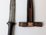 two knives that are on the wall next to each other