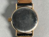 a close up of a watch on a table