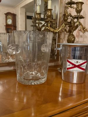 bottles and glasses on a wooden table with a mirror in the background