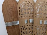 four wooden skis that are lined up on a table
