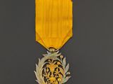 an image of a medal with a gold ribbon on a black background