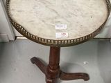 a small table with a marble top on a stand