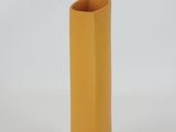 a yellow vase that is sitting on a white surface