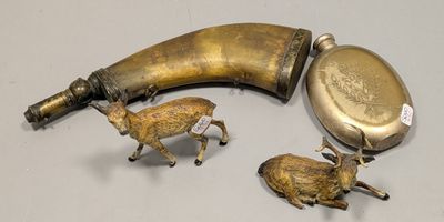 two figurines of animals and a horn on a table