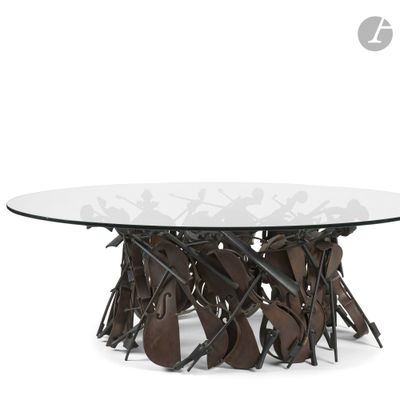 a round glass table with metal legs and a glass top