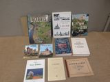 several books are sitting on a table in front of a wall