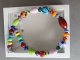brightly colored beaded bracelet in a white box on a table