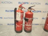 three fire extinguisors sitting next to each other on a table