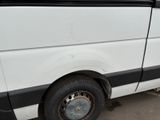 a white van that is parked in a parking lot