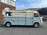 a blue and white food truck parked in a parking lot