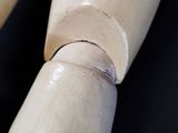 a close up of a wooden object with a black background
