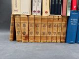 several books are stacked on top of each other in a row