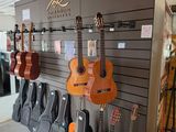 many guitars on display in the store for sale