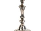 a close up of a silver candle holder on a white background