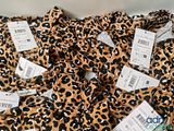 a close up of a pile of clothes with price tags on them