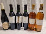 several bottles of wine are lined up on a table