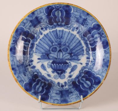 a blue and white plate with a fan design on it