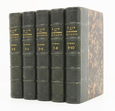 three books are stacked on top of each other on a white surface