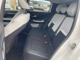 the back seats of a white car with black trims