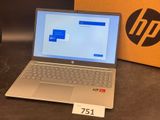 hp laptops are on display in a store with a box on the table