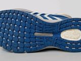 adidas running shoes on a white surface with a blue and white sole
