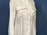 an image of a white shirt on a mannequin stand