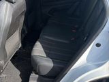a car with the door open sitting in a parking lot