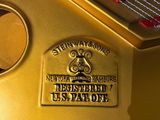 a close up of a golden piano with the keys missing