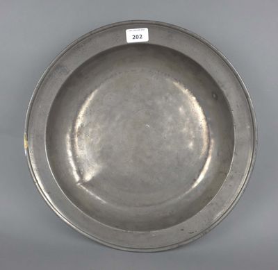 une assiette en argent ancien sur laquelle est apposée une étiquette
